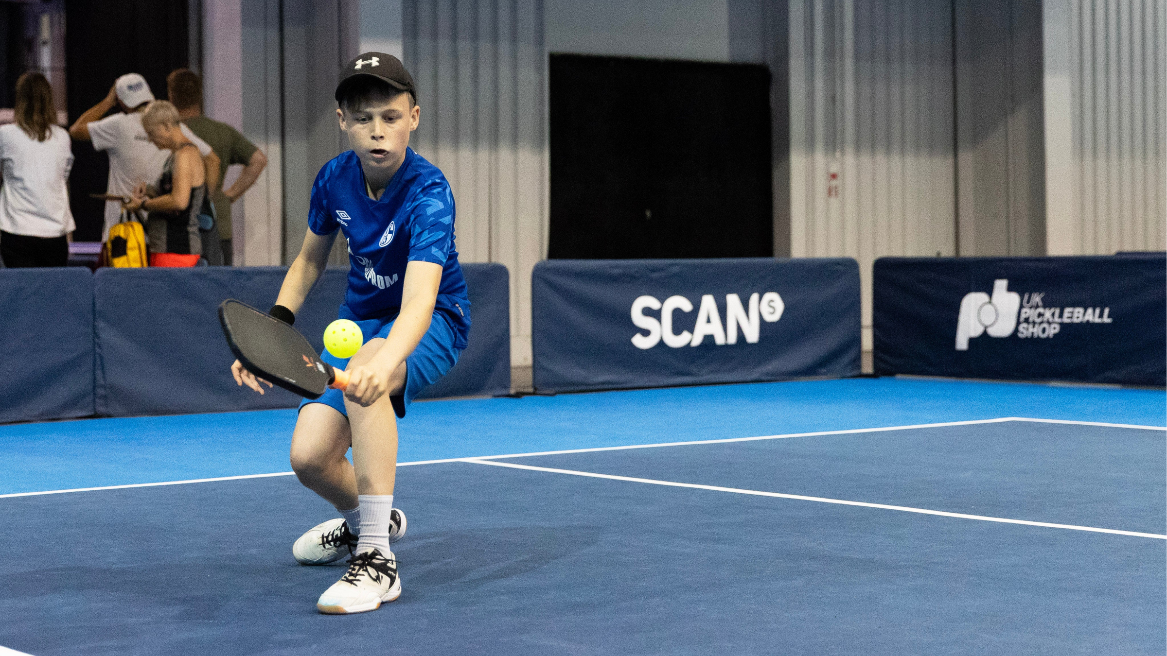 Boy plays pickleball