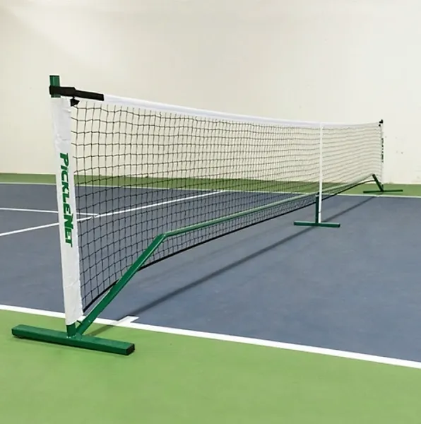 A portable pickleball net system with green poles and a white net, set on a pickleball court.